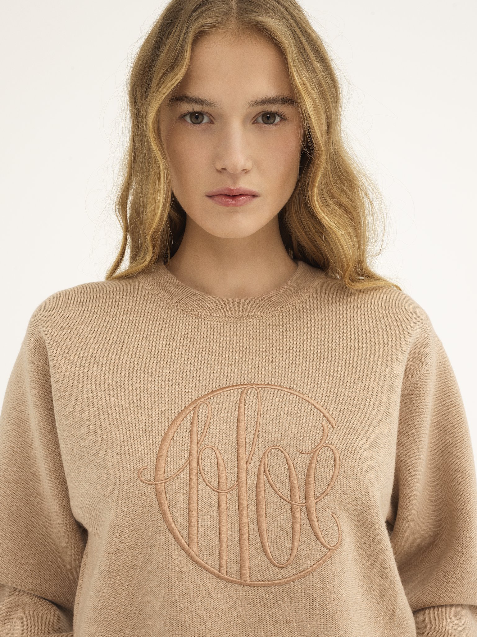 Knitted logo sweater in wool Lower-impact signature knit
Straw Beige Front view of the product being worn