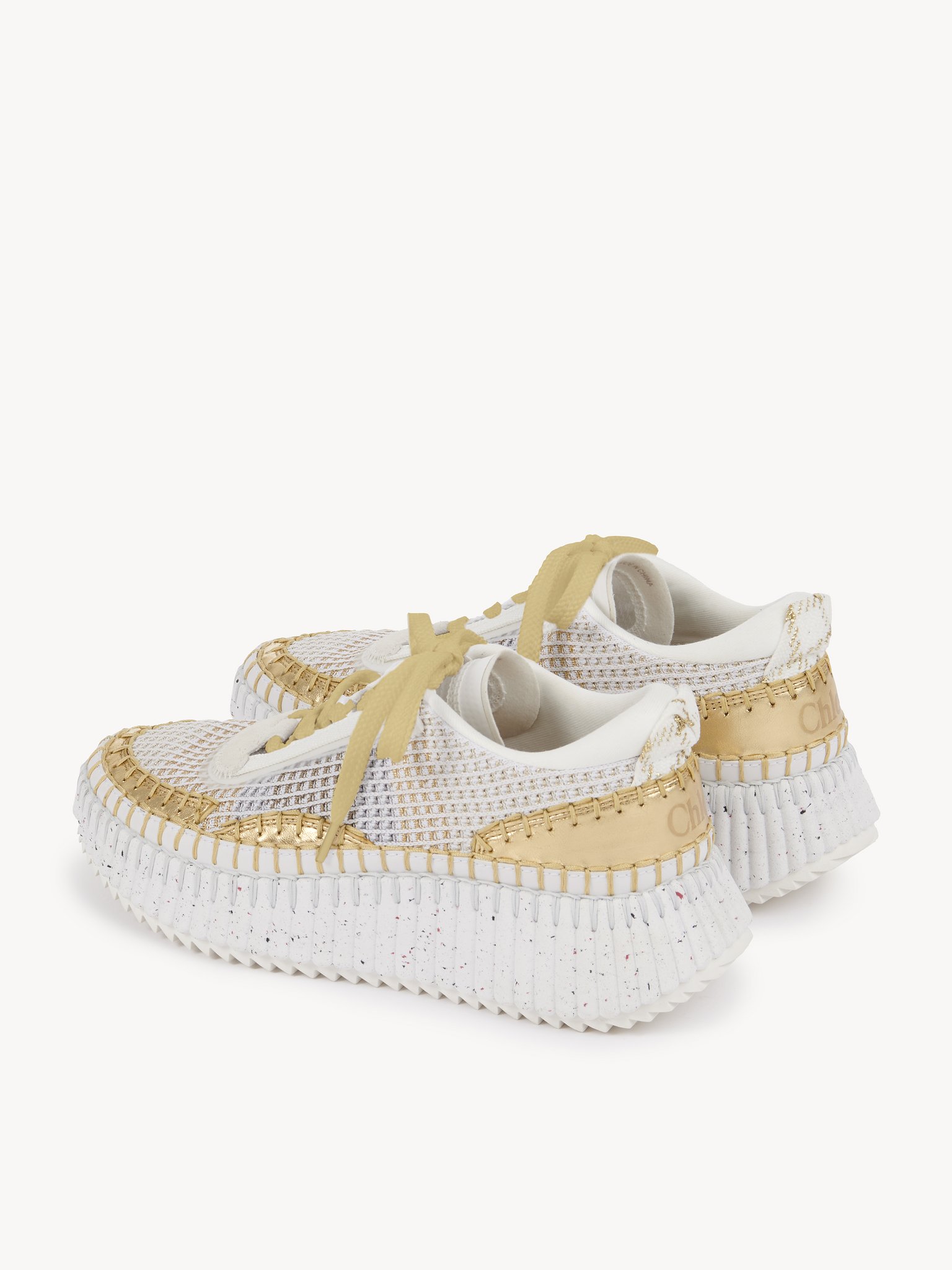 Nama sneaker Lower-impact mesh & crackled calfskin
Gold Front view of the product being worn