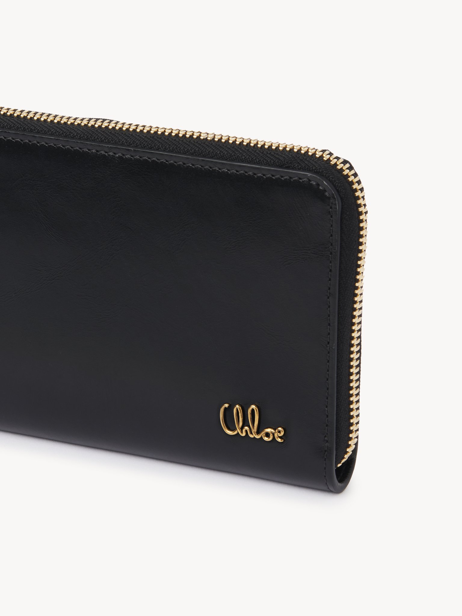 Chloé Iconic zipped long wallet in shiny leather Shiny calfskin
Black Front view of the product being worn