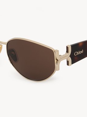 Marcie sunglasses Lower-impact acetate, metal & bio-based nylon
Shiny classic gold & shiny medium Havana, solid light brown lenses Top view of the product