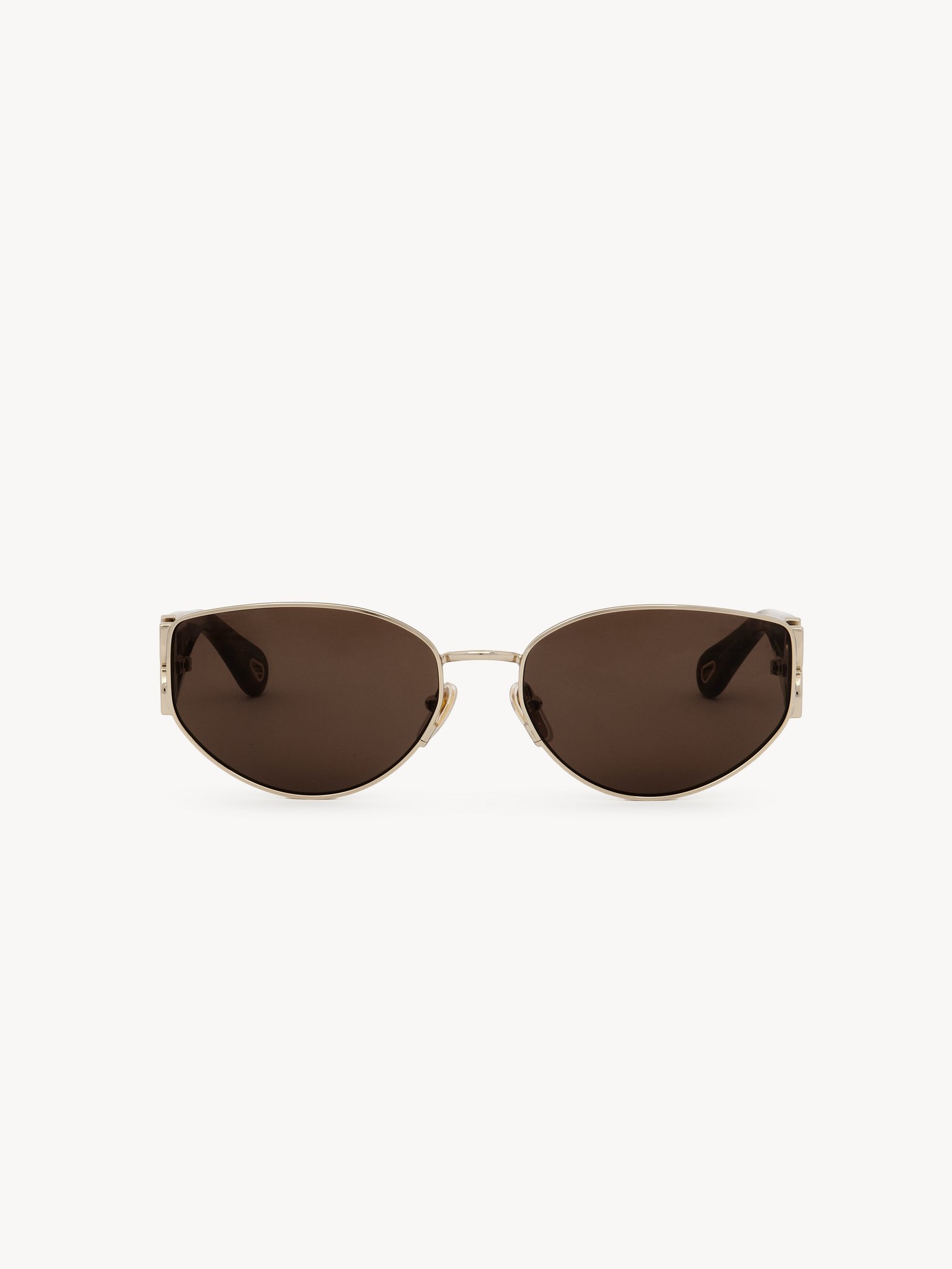 Marcie sunglasses Lower-impact acetate, metal & bio-based nylon
Shiny classic gold & shiny medium Havana, solid light brown lenses Back view of the product