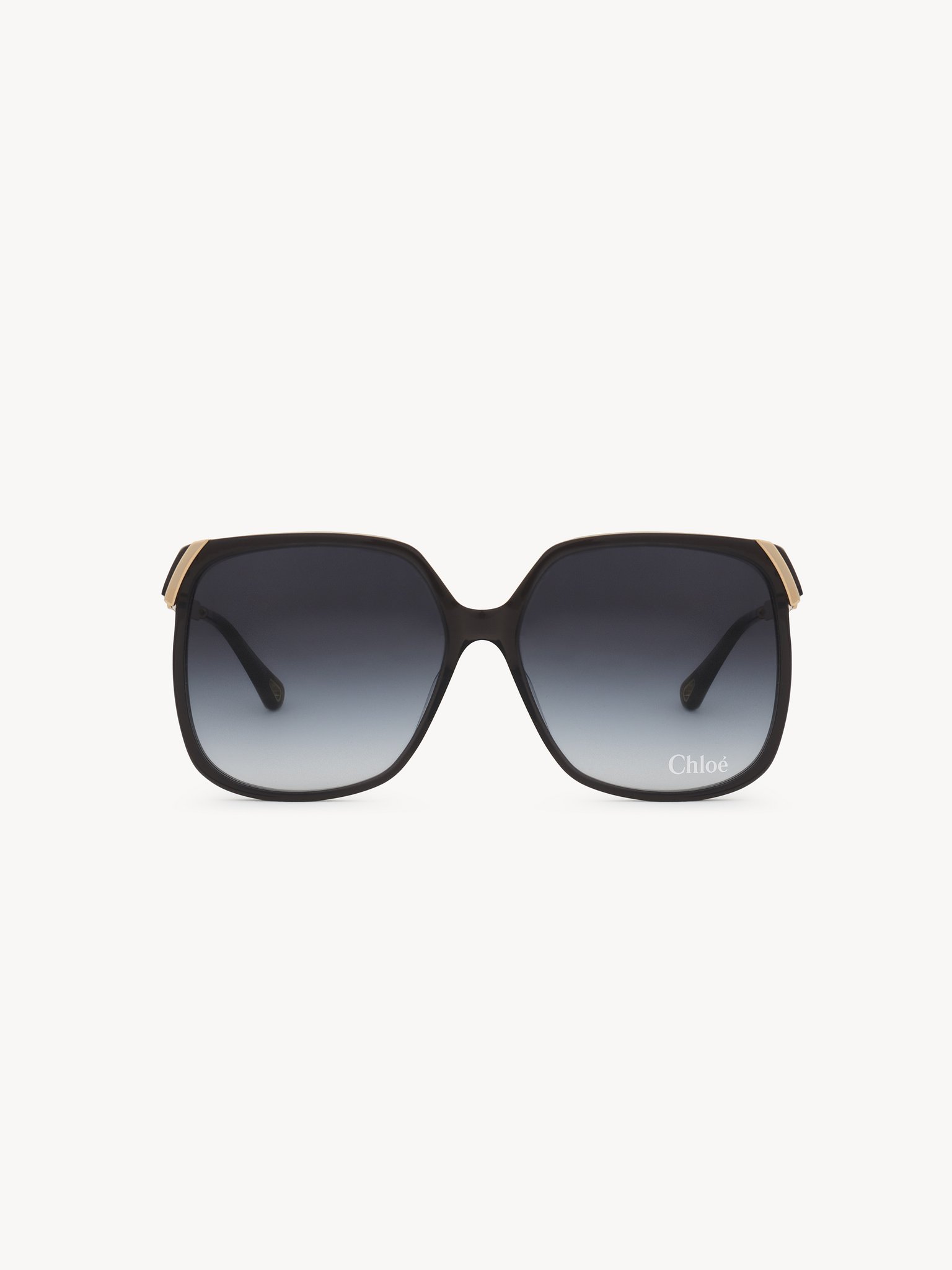 Aly sunglasses Dark gray lower-impact acetate, gold metal & bio-based nylon
Gradient blue lenses Back view of the product