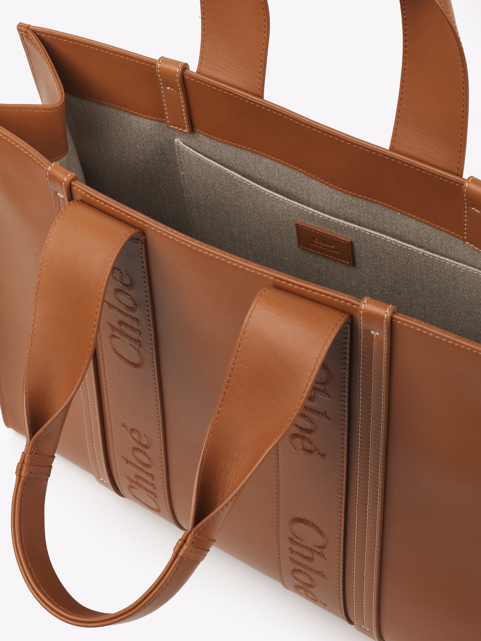 Large Woody tote bag in soft leather Smooth calfskin with Chloé logo
Caramel Front view of the product being worn