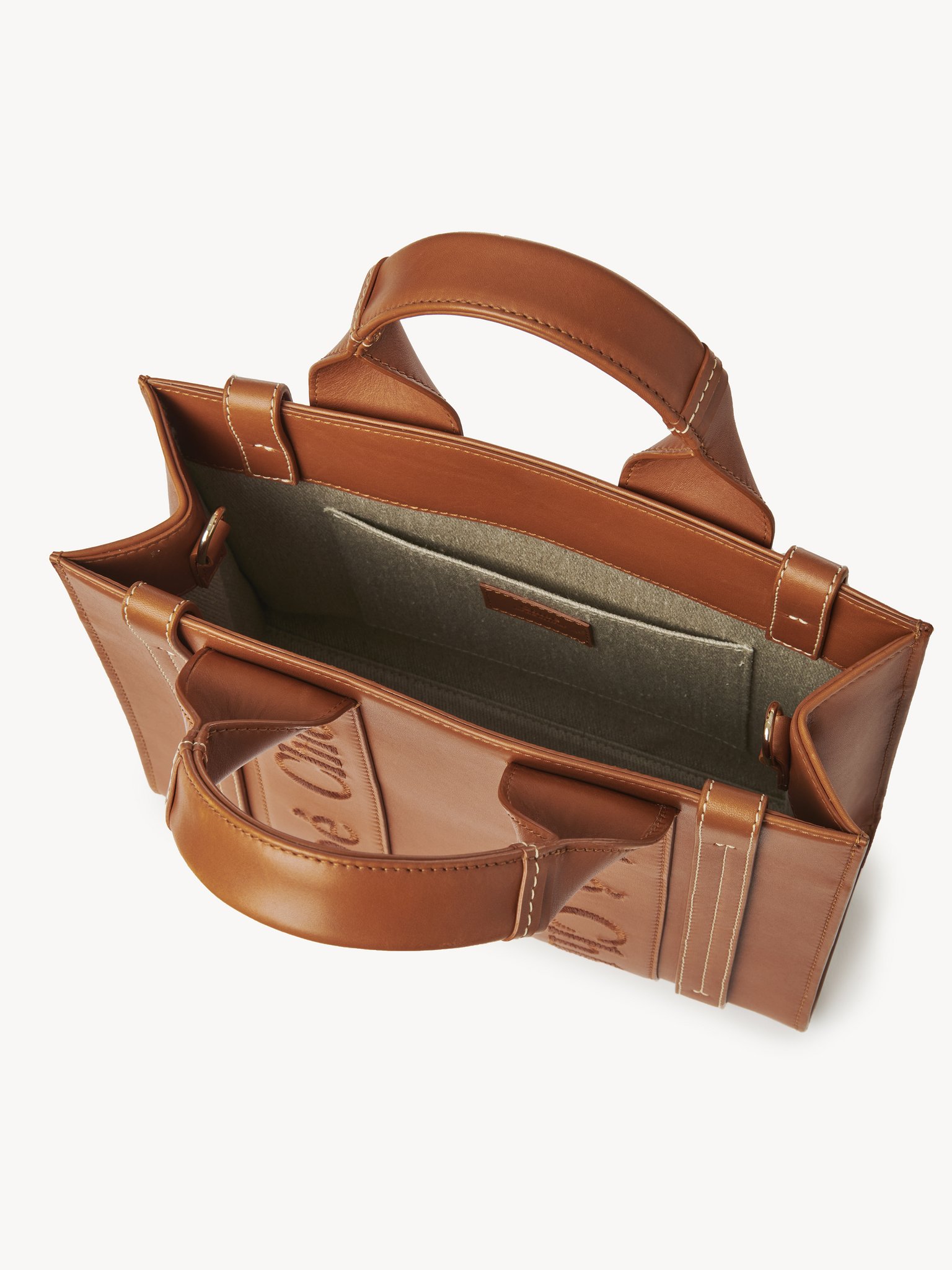 Small Woody tote bag Smooth calfskin with Chloé logo
Caramel Front view of the product being worn