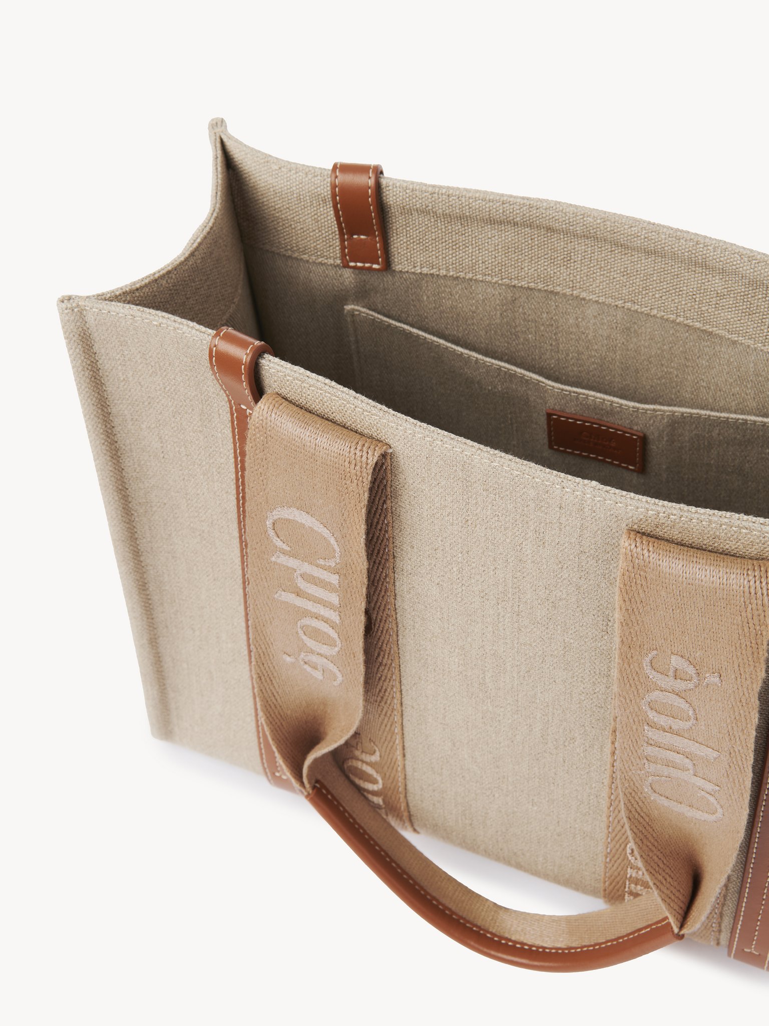 Woody tote bag in linen Linen canvas, calfskin & webbing with Chloé logo
Soft Tan Front view of the product being worn