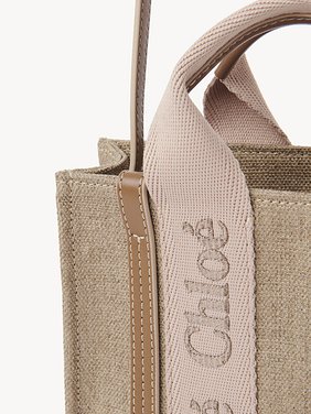 Mini Woody tote bag in linen Linen canvas & shiny calfskin with Chloé logo
Blushy Beige Front view of the product being worn