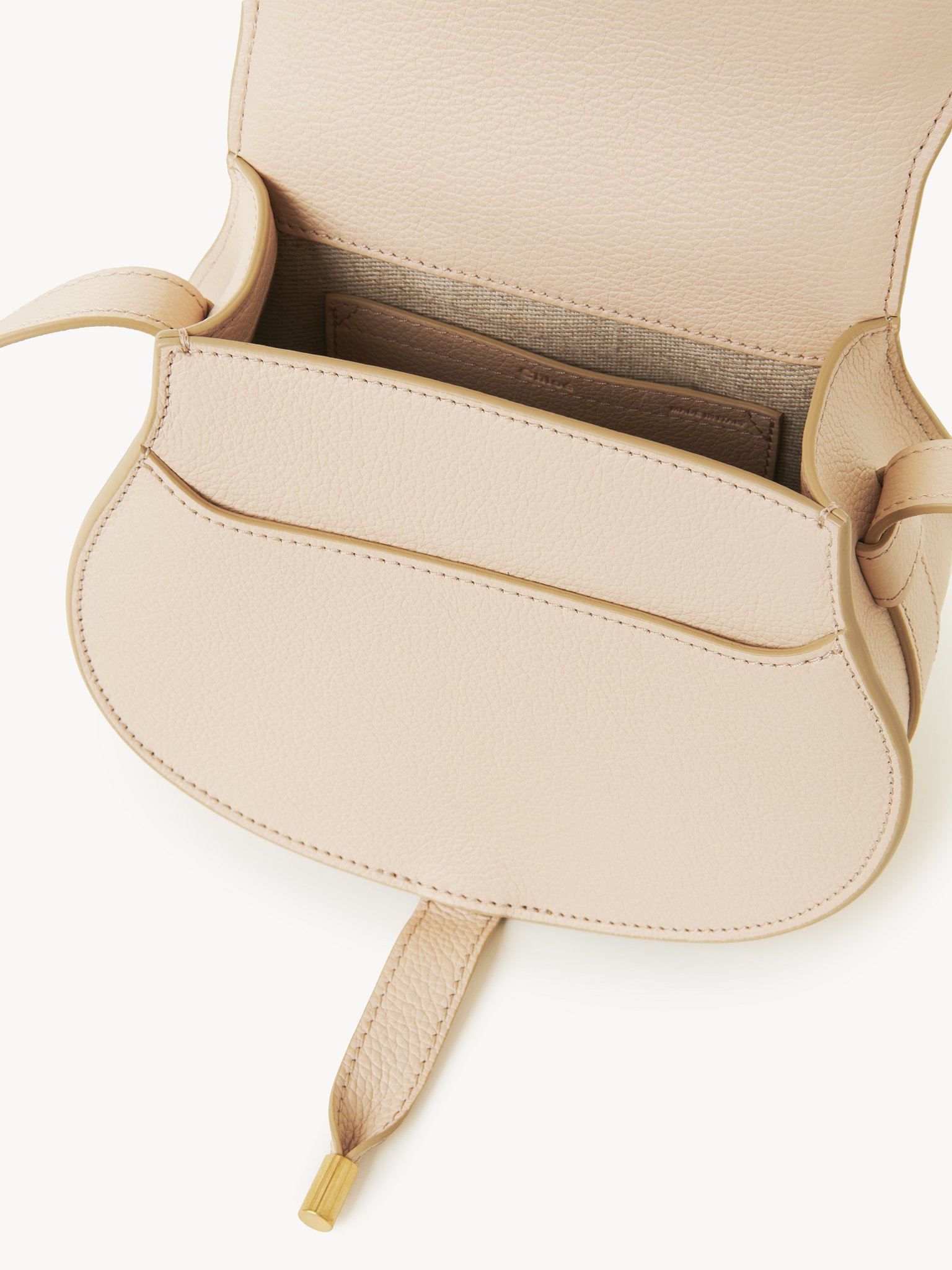 Small Marcie saddle bag in grained leather Grained calfskin
Cement Pink Front view of the product being worn