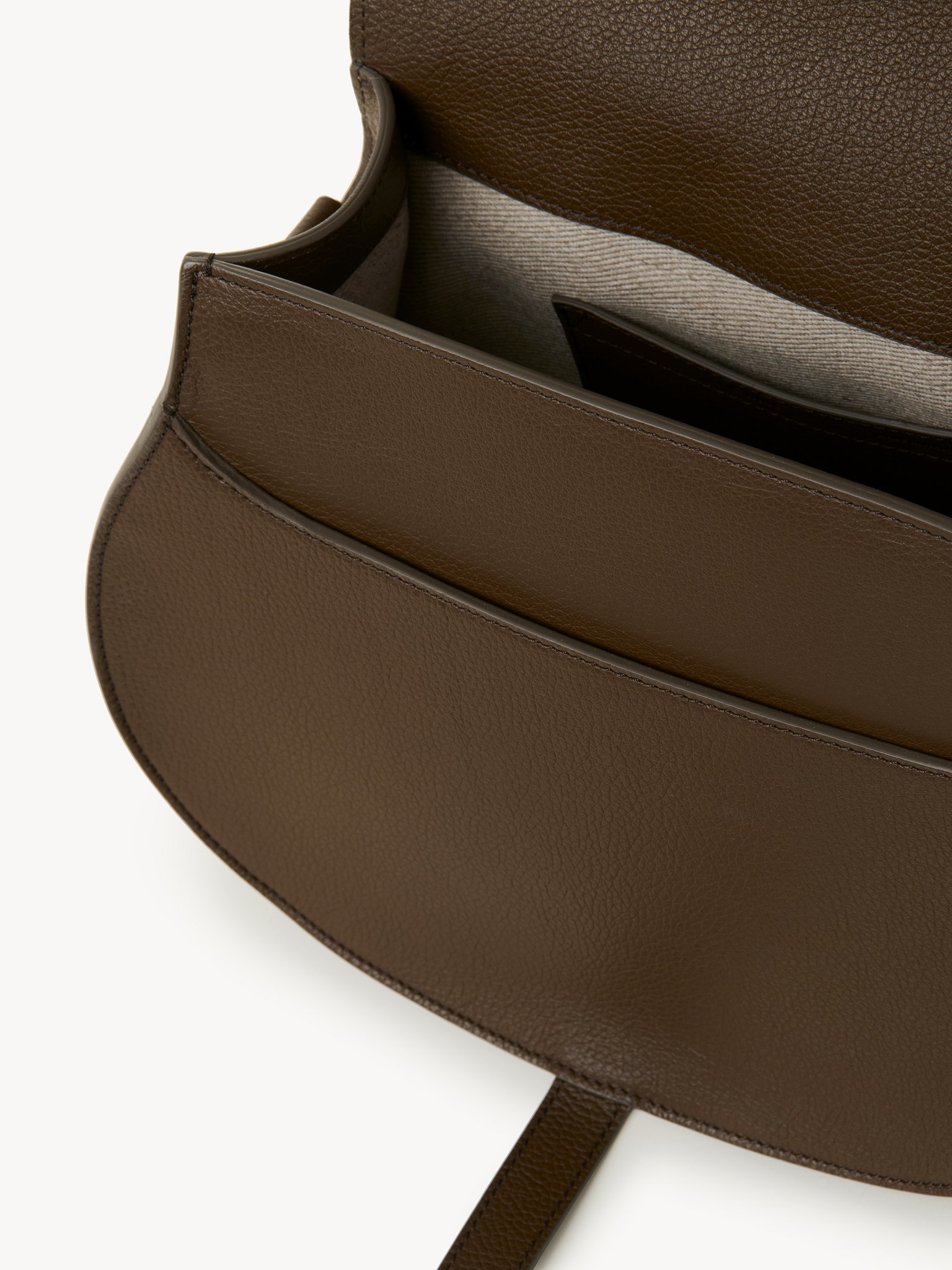 Marcie saddle bag in grained leather Grained calfskin
Dark Khaki Front view of the product being worn