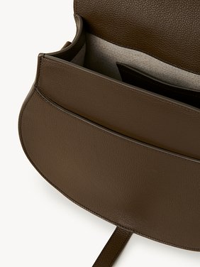 Marcie saddle bag in grained leather Grained calfskin
Dark Khaki Front view of the product being worn