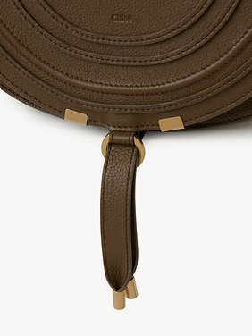 Marcie saddle bag in grained leather Grained calfskin
Dark Khaki Front view of the product being worn