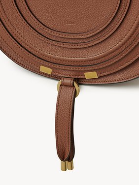 Marcie saddle bag in grained leather Grained calfskin
Tan Front view of the product being worn