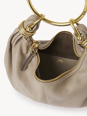 Small Bracelet hobo bag in grained leather Shiny grained calfskin
Motty Grey Front view of the product being worn