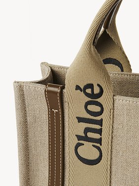 Small Woody tote bag in linen Linen canvas, calfskin & webbing
Bronze Brown Front view of the product being worn