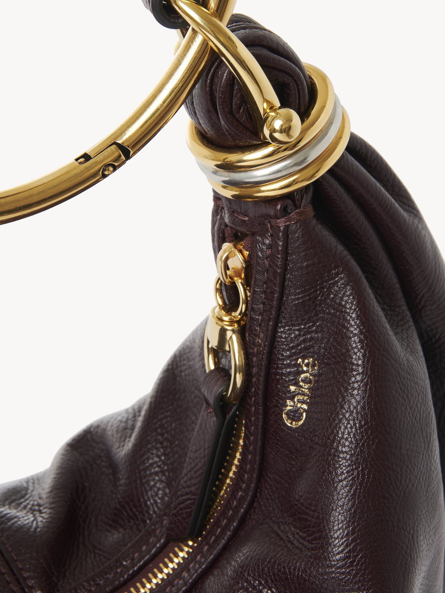 Small Bracelet Hobo bag in grained leather Shiny grained calfskin
Deep Violine Front view of the product being worn