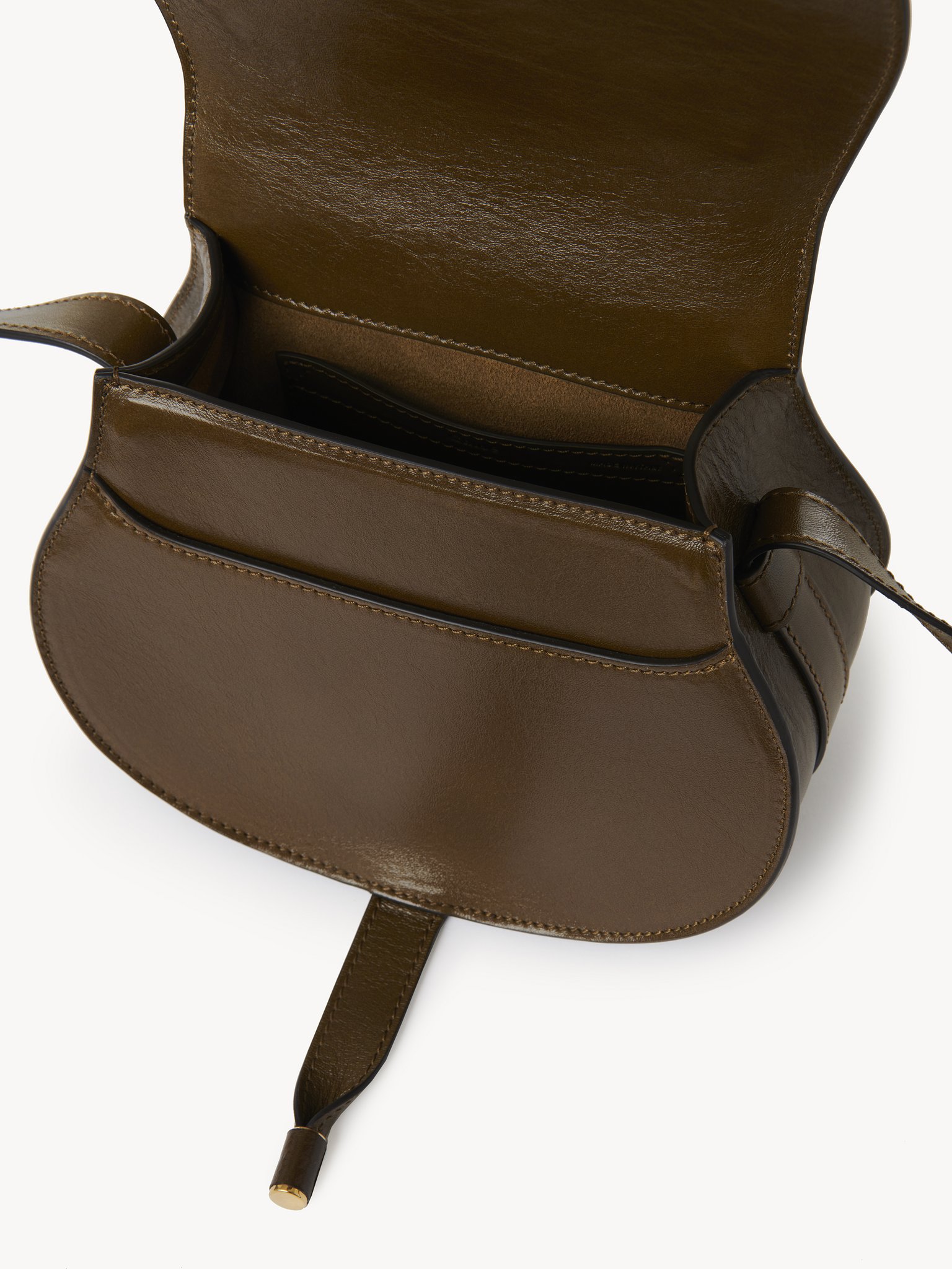 Small Marcie saddle bag in shiny leather Shiny calfskin
Dark Khaki Front view of the product being worn