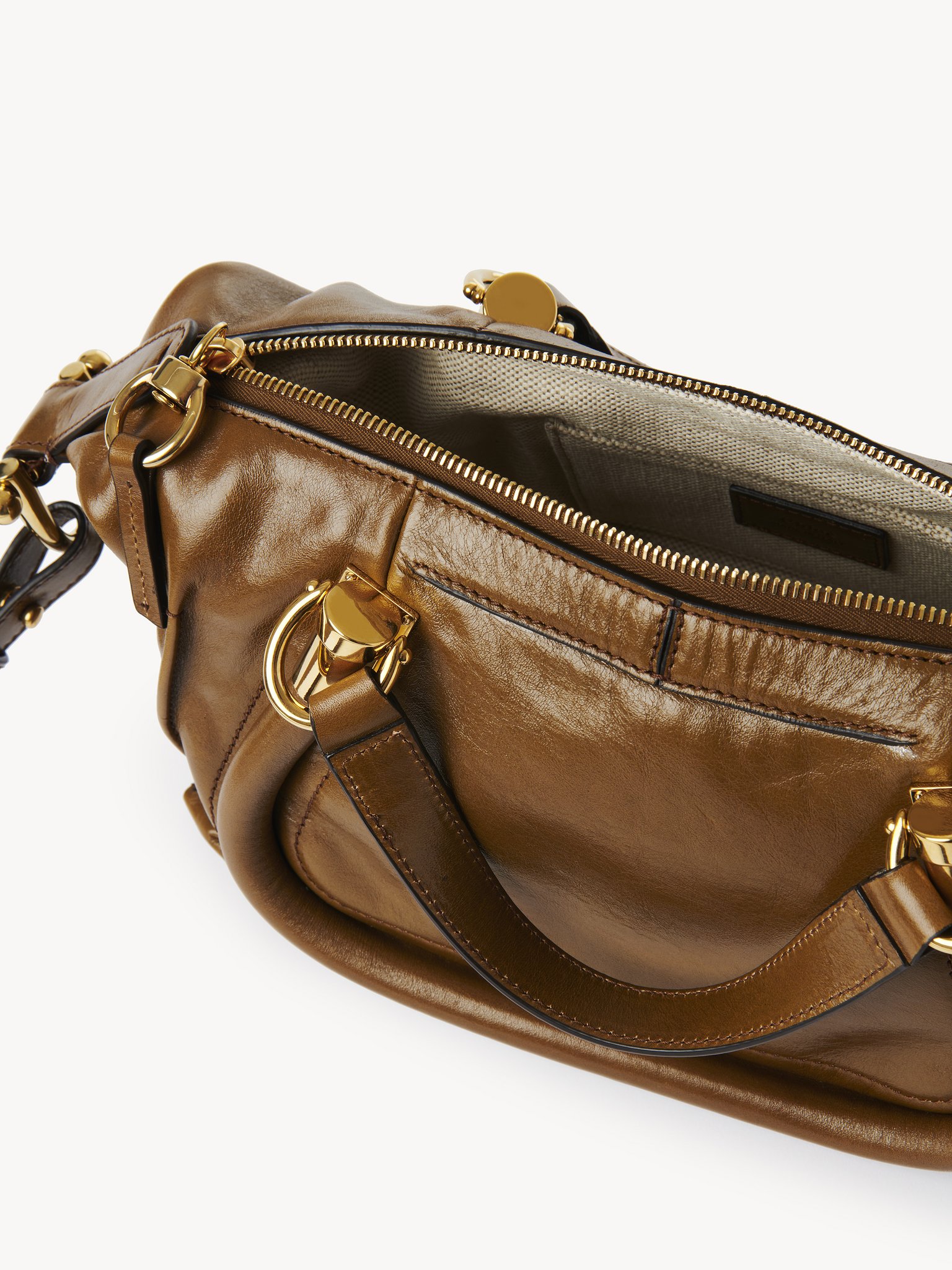 Small Paraty 24 bag in shiny leather Natural shiny calfskin
Bronze Brown Front view of the product being worn