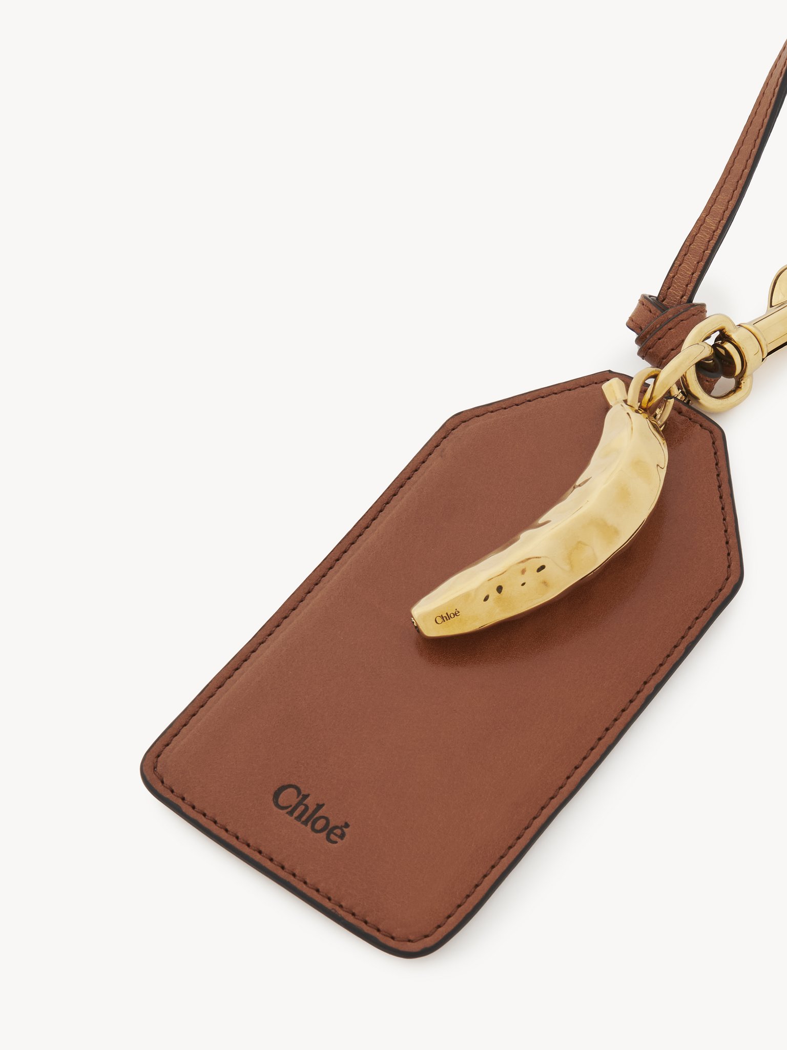 Banana tag in shiny leather Natural shiny buffalo leather
Clay Brown Product detail