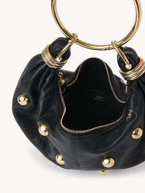 Small Bracelet Hobo bag in grained leather with studs Shiny grained calfskin with oversized studs
Black Front view of the product being worn