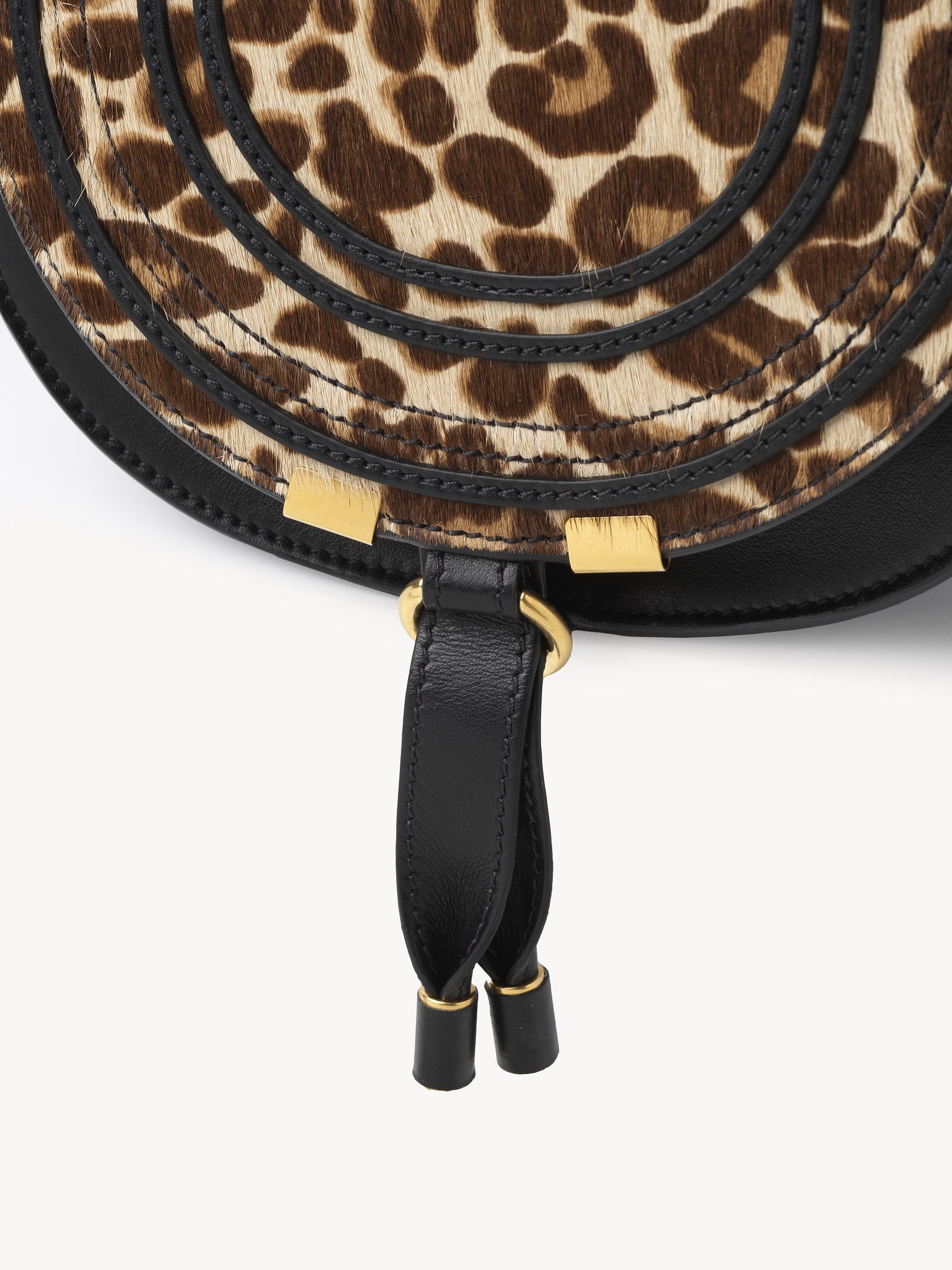 Small Marcie saddle bag in leopard-print leather Leopard-print pony calfskin
Jungle Brown Front view of the product being worn