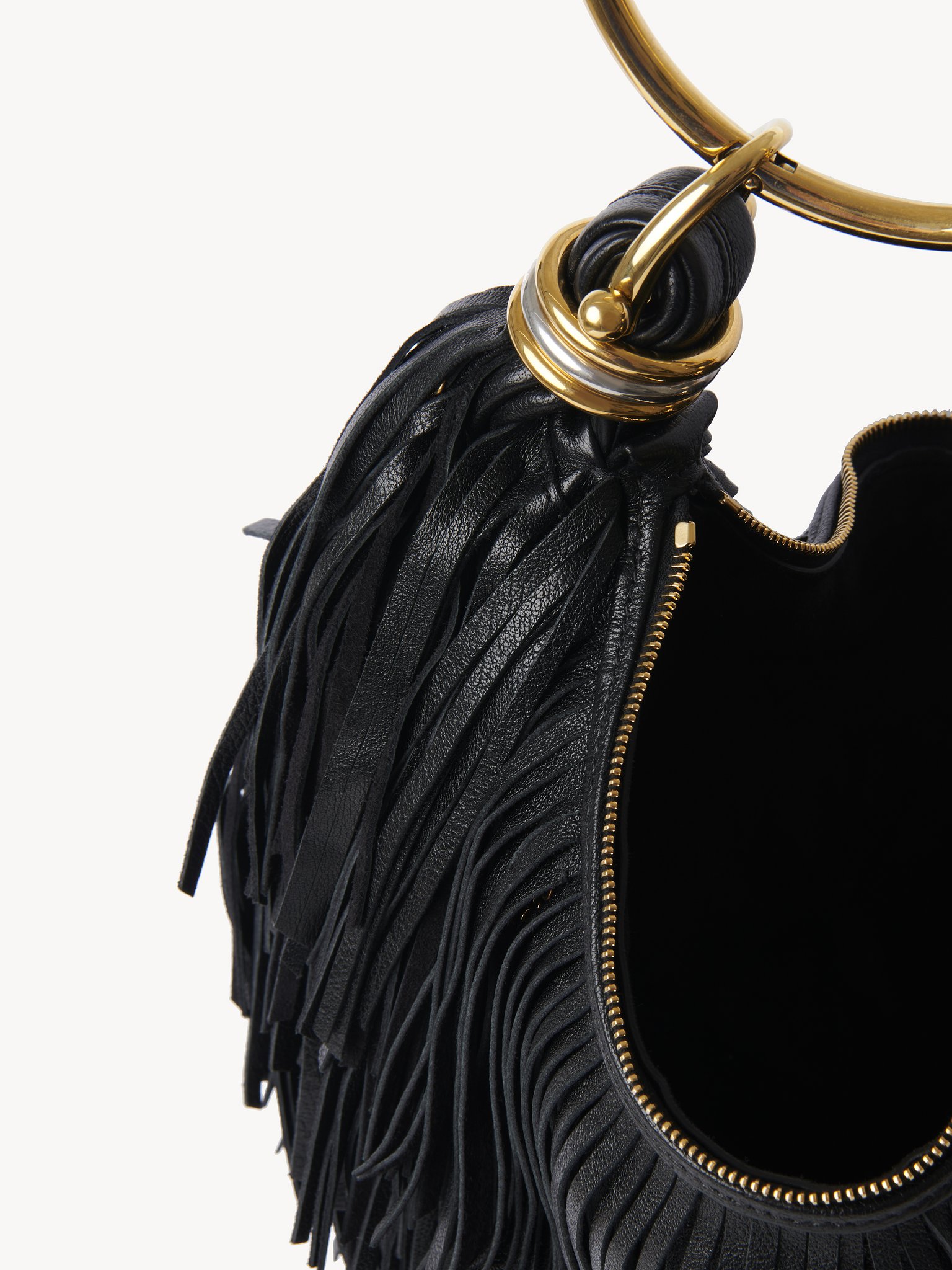 Small Bracelet Hobo bag in fringed leather Fringed buffalo leather with metal ornaments
Black Front view of the product being worn