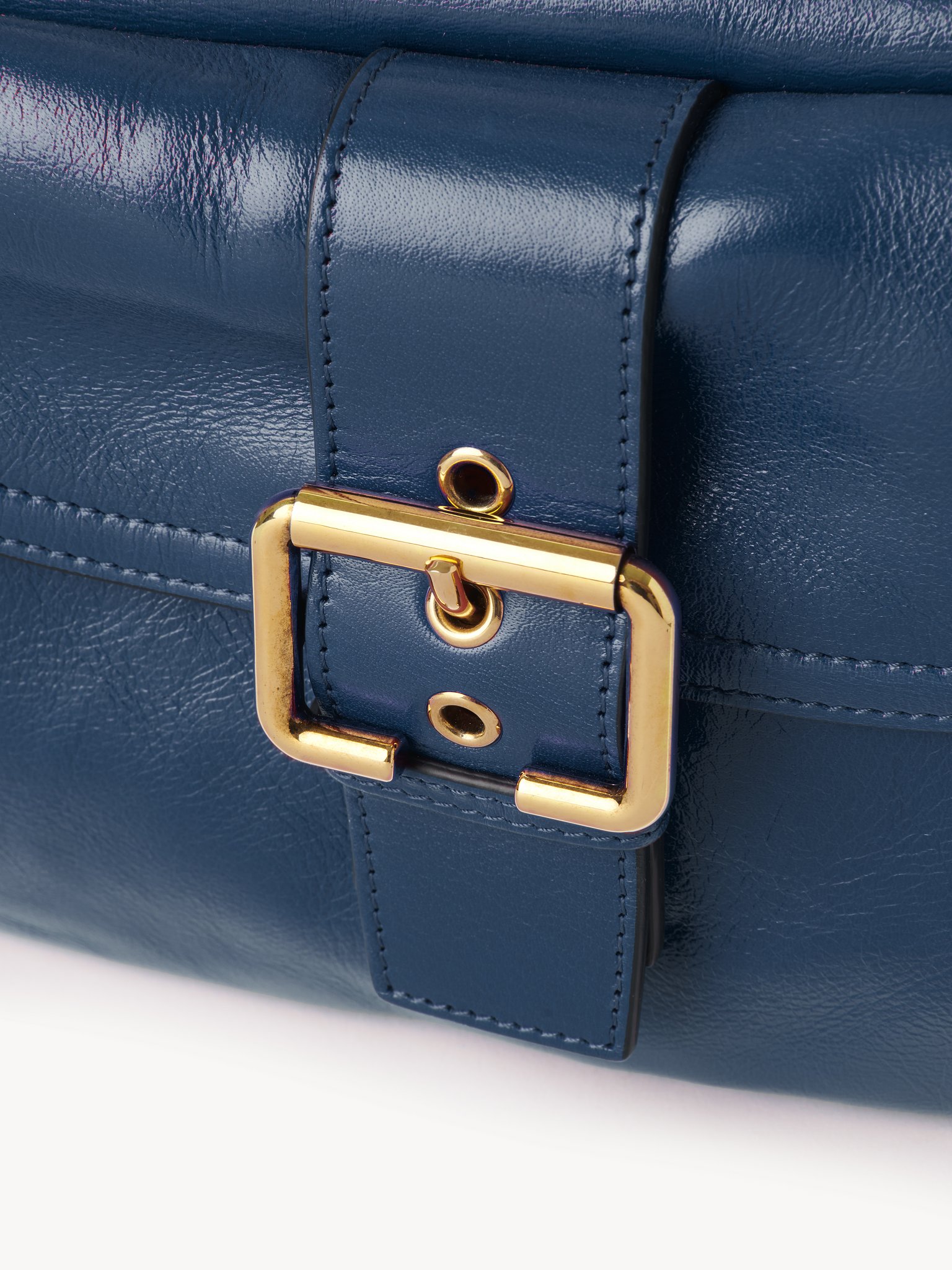 Camera bag in shiny leather Natural shiny buffalo leather
Tapestry Blue Front view of the product being worn